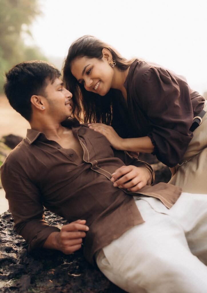 Candid pre-wedding moment on a Goa beach, couple in brown linen, by Pavan Soni