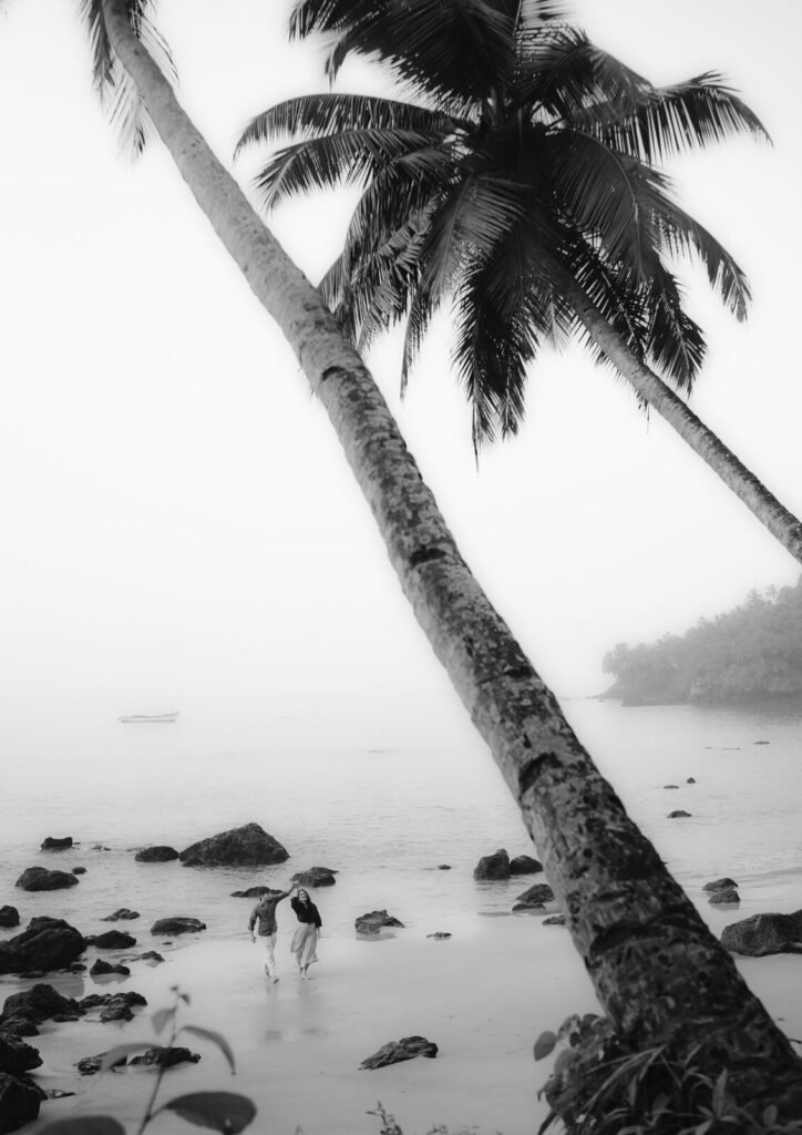 Black and white Goa beach pre-wedding frame under palm trees by Pavan Soni
