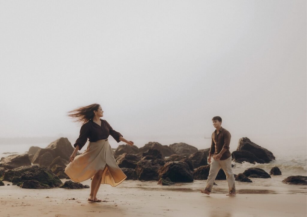 Couple walking on a misty Goa beach at sunrise, pre-wedding photography by Pavan Soni